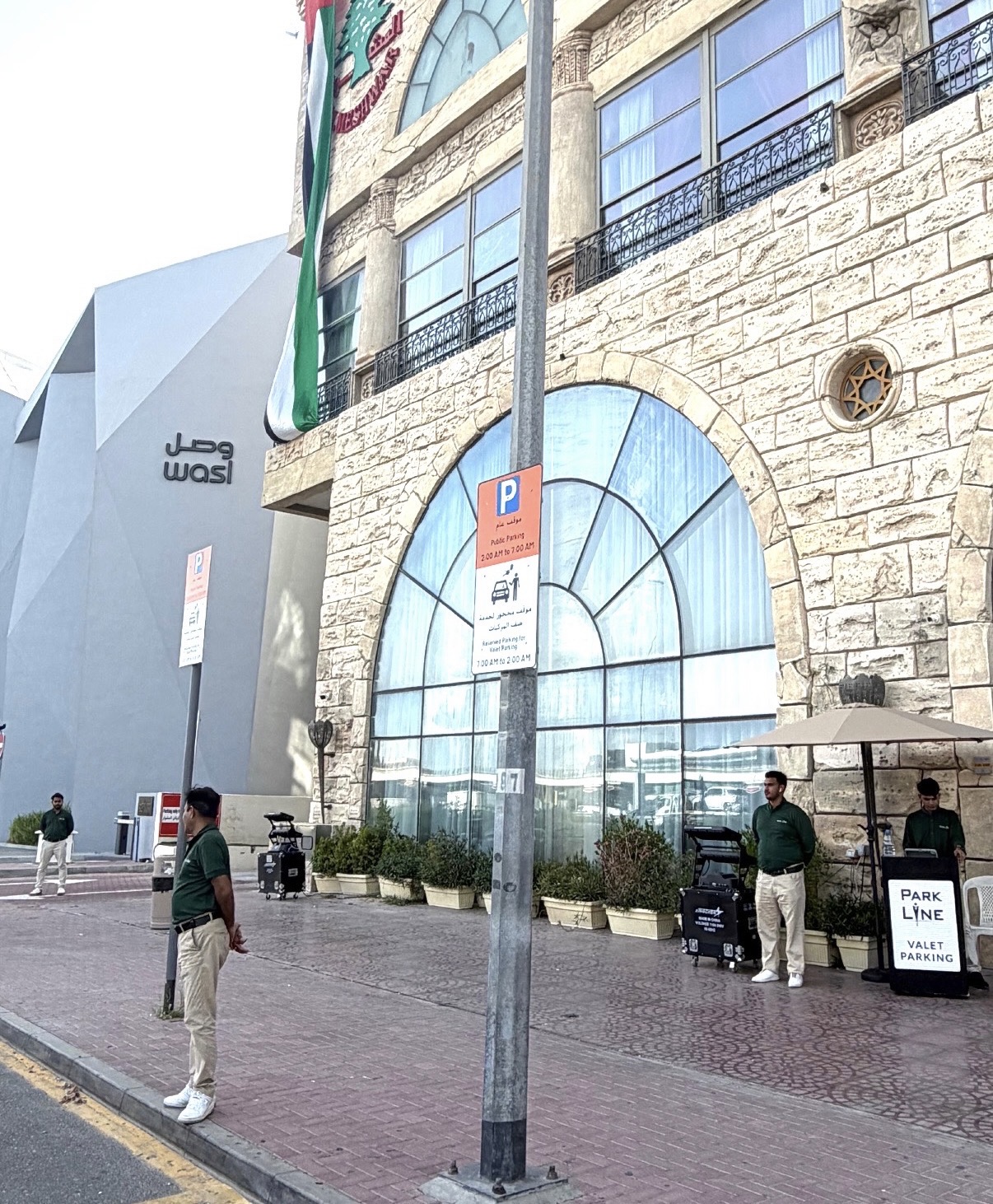 Parkline attendants and valet stand outside a restaurant